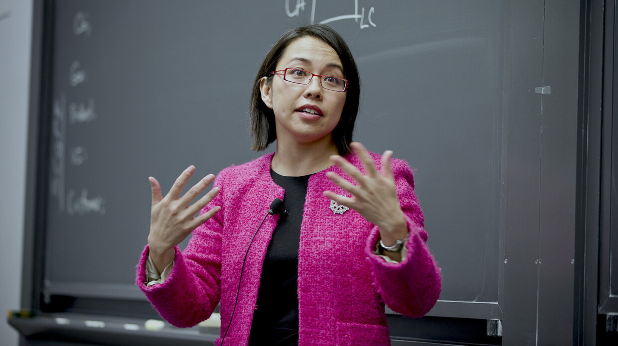 Pai-Ling Yin, senior manager of research science, is seen speaking to a classroom, there is a chalkboard behind her and she is gesturing with her hands.